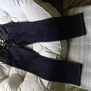 Just USA low rise skinny blue jeans with neon green stitching.